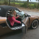 In this public exposure clip, a pretty, blonde, German girl gets out of a car, then squats on the side of the road in full view of other cars passing by while taking a runny shit on the pavement. Presented in 720P HD. About 1.5 minutes.